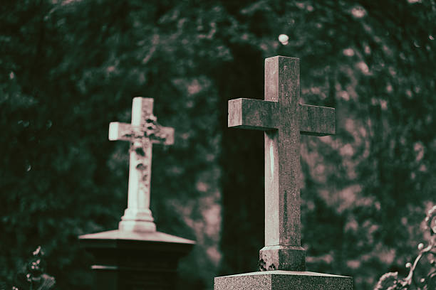Old Christian cemetery with blurry grave background.