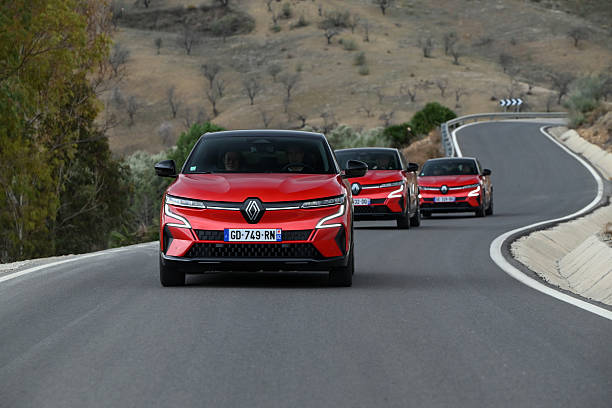Malaga, Spain - 4th February, 2022: Three electric cars Renault Megane E-Tech driving on a road. This model is the first mass-produced electric compact car from Renault.