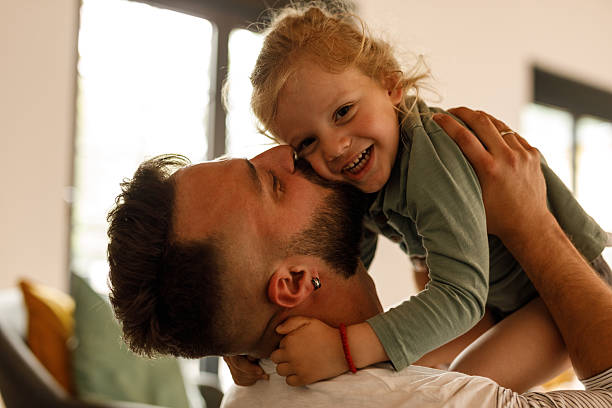 istock Cute little toddler laughing and having fun while playing with his father 2239240859