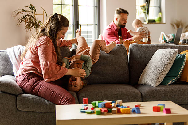 istock Caring woman and her toddler having fun, bonding moments while playing on the sofa 2239240894