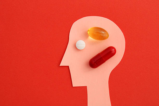 istock Person taking several types of medication, head silhouette 2239243960
