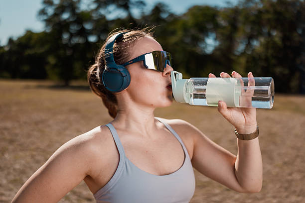 istock Athletic Woman Drinking Water Outdoors 2239247102