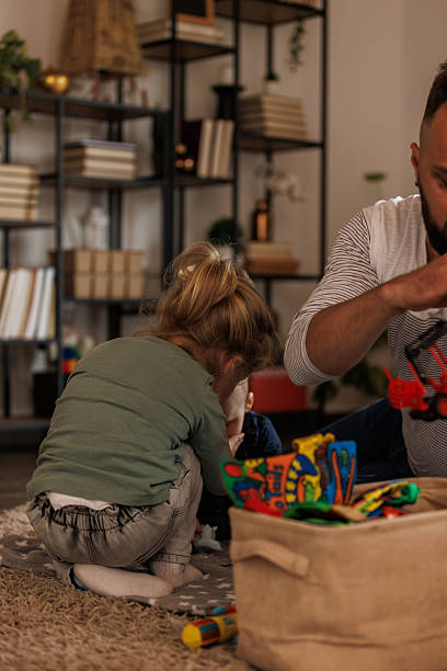 istock Father caring for his two boys who are playing on the floor 2239252477
