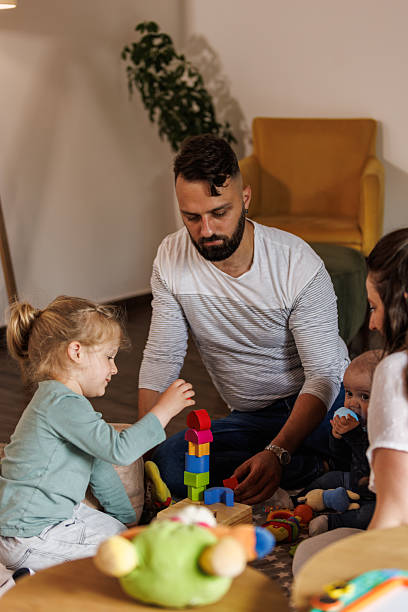 istock Parents playing on the floor with their toddler son 2239252930