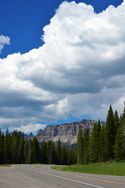 Wyoming, USA: Togwotee Pass, situated on the Continental Divide in the Absaroka Mountains of northwestern Wyoming, is a high mountain pass with an elevation of 9,658 feet (2,944 meters). Traversed by U.S. Highways 26 and 287, it serves as a critical transportation link between Dubois and Moran Junction, offering the most direct route to Grand Teton National Park from the east. The pass is located within the Bridger-Teton and Shoshone National Forests, making it a significant area for year-round recreation. During the winter, it receives substantial snowfall, attracting snowmobilers and skiers, while in the summer, it is a destination for hiking, offering expansive views of the Teton Range and surrounding wilderness. The region is characterized by its alpine meadows, coniferous forests, and prominent geological features such as the Pinnacle Buttes and Breccia Cliffs.