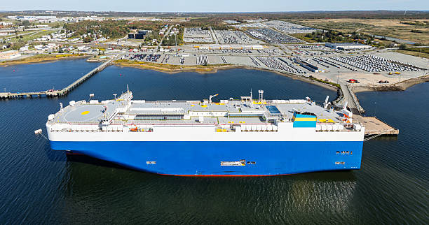 Ro-Ro Ship for import export shipping cars by Vessel Freight forwarding service ship, Logistics transportation to dealer and commercial port background aerial view