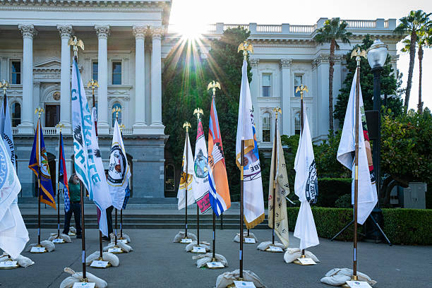Sacramento, CA, U.S.A. - Sept. 26, 2025: Display of tribal flags at the State Capitol with sunburst.
