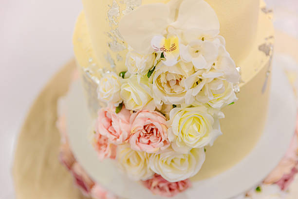 istock Beautiful white wedding cake decorated with flowers close up 2239273687