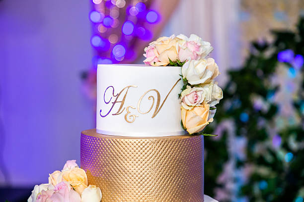 istock Beautiful white wedding cake decorated with flowers close up 2239273880