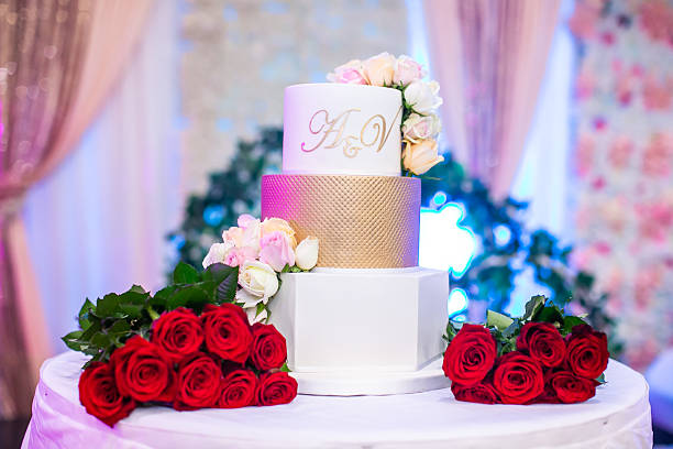istock Beautiful white wedding cake decorated with flowers close up 2239273898