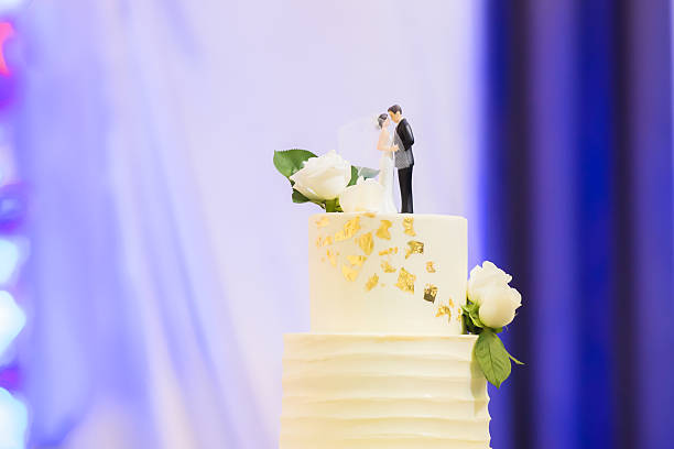 A broken wedding cake topper. Can symbolize divorce or a broken marriage.