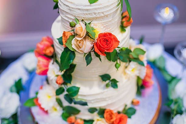 istock Beautiful white wedding cake decorated with flowers close up 2239274503