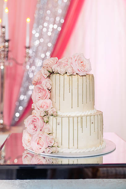 istock Beautiful white wedding cake decorated with flowers close up 2239274612