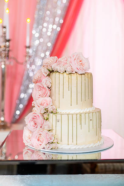 istock Beautiful white wedding cake decorated with flowers close up 2239274613