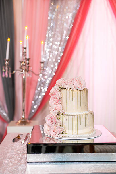 istock Beautiful white wedding cake decorated with flowers close up 2239274623