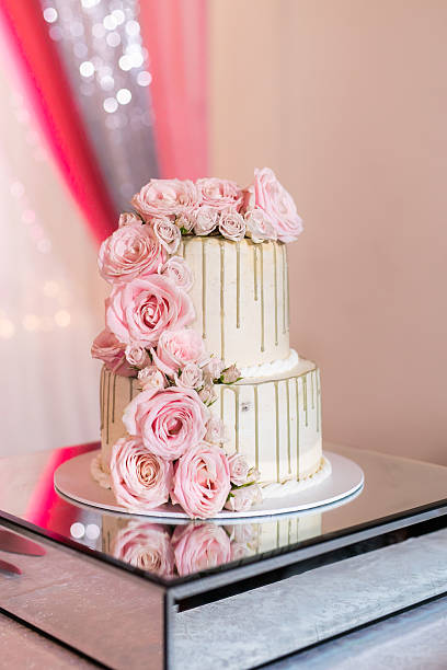 istock Beautiful white wedding cake decorated with flowers close up 2239274629