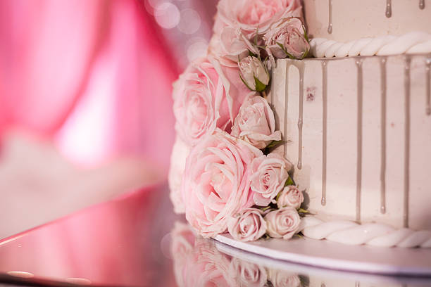 istock Beautiful white wedding cake decorated with flowers close up 2239274656