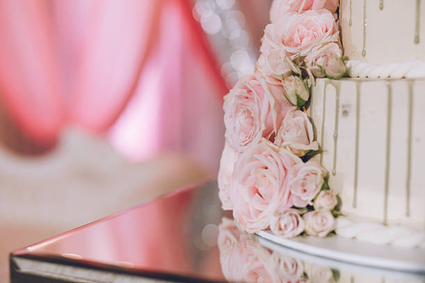 Beautiful white wedding cake decorated with flowers close up