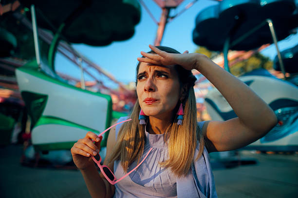 istock Woman Looking Skeptical at Amusement Park Dangerous Rides 2239274675