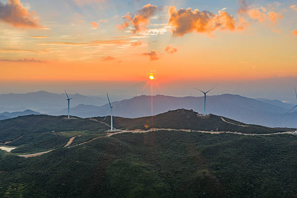 istock Wind turbines on a mountain at sunset, windmills, wind energy 2239279307