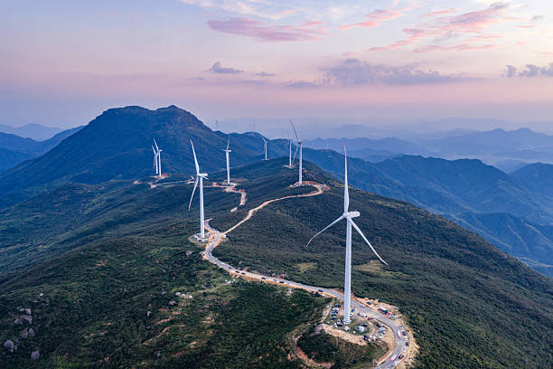 istock Wind turbines on a mountain at sunset, windmills, wind energy 2239279437