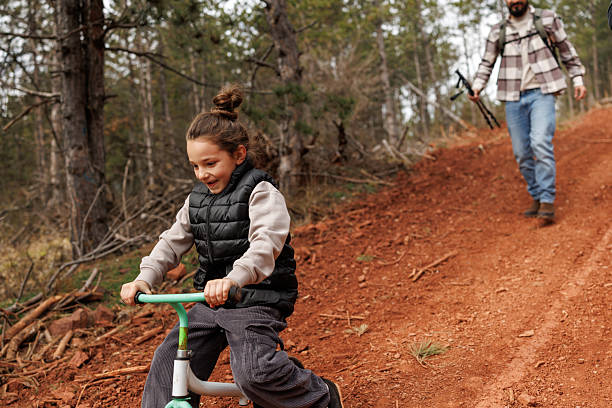 istock Devoted father teaching his son to ride bicycle in nature 2239279634
