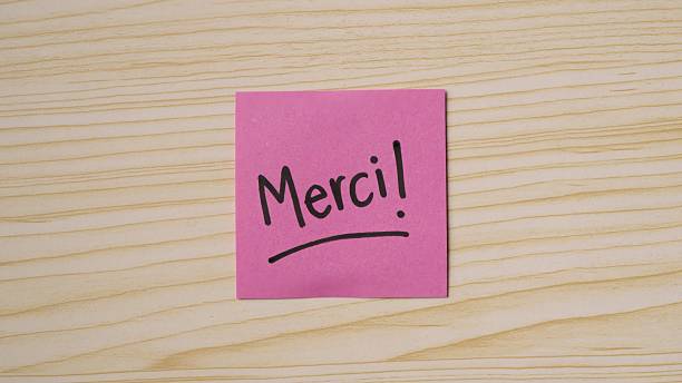 istock Positive Handwritten Merci! message on sticky note. Handwritten Thank you!! message on sticky note 2239279638