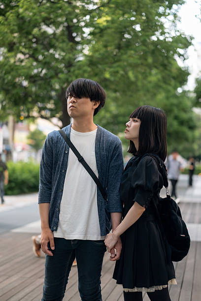 istock Couple standing on city street 2239280970