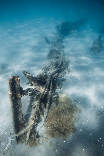 istock Underwater ocean with wreck ship on sandy sea bottom 2239283167