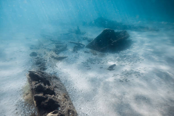 Underwater sea with wreck ship on sandy sea bottom in sea