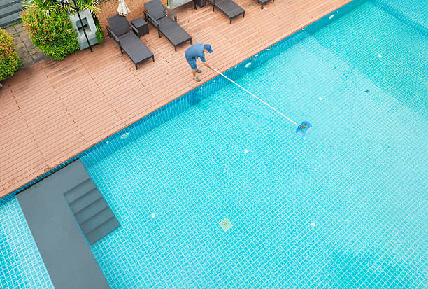 istock Pool maintenance with scoop net to capturing the leaves on the surface of pool. 2239284621