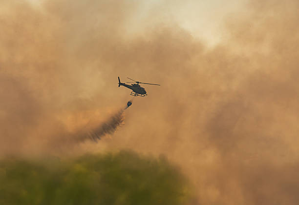 istock Fire fighting helicopter carry watethar bucket to extinguish the forest fire. 2239284691
