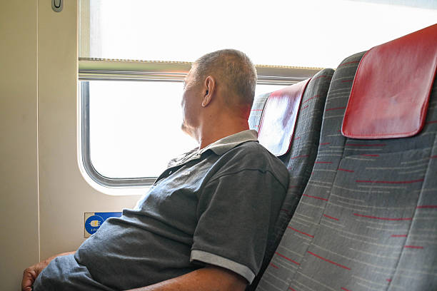 istock Serenity on the Rails: Old Man Traveling Alone 2239285240
