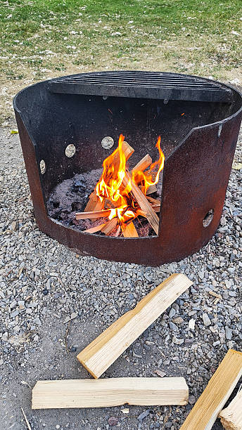 istock Vibrant flames flicker in a rusty metal fire pit with a grill top 2239286983