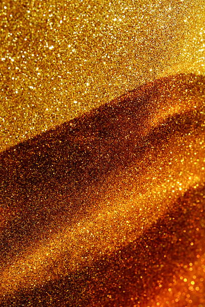 Abstract gold sparkles background with sunlight shadow template with copy space. Banner.Christmas, holiday backdrop, wallpaper.