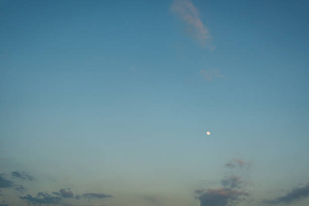 Moon against blue sky. Small disk of the moon against a blue sky.