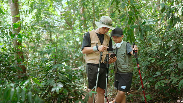 istock Father guides son through forest hike while exploring nature and learning about wildlife together 2239291301