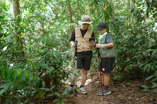 istock Father guides son through forest hike while exploring nature and learning about wildlife together 2239291310