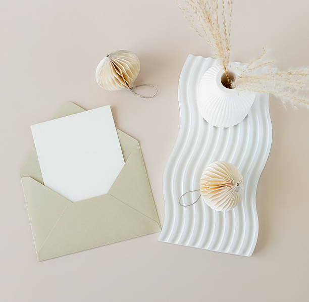 istock Envelope with blank paper card mockup inside top view and minimalist decor on beige background . Copy space 2239291384