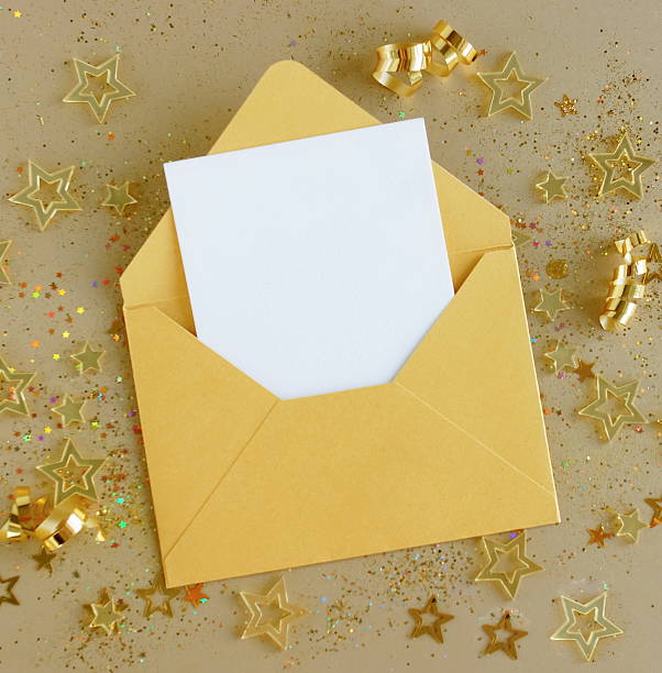 istock Envelope with blank paper card mockup inside top view and gold Christmas decor on beige background . 2239291984