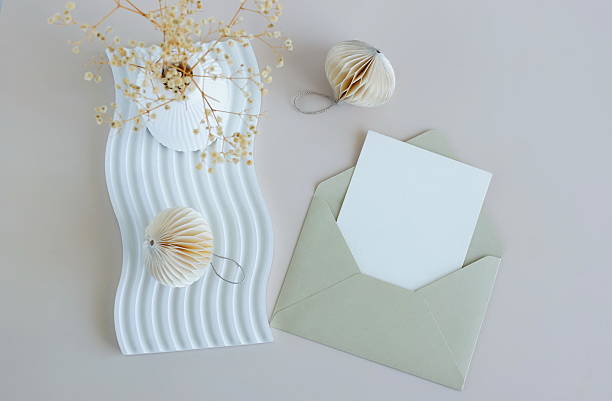 istock Envelope with blank paper card mockup inside top view and minimalist decor on beige  background . Copy space. 2239292000