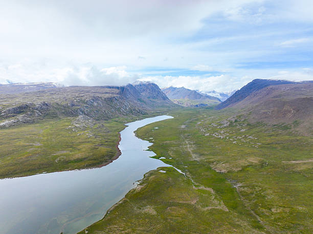 istock Serpentine lake winding through a wide green valley 2239294587