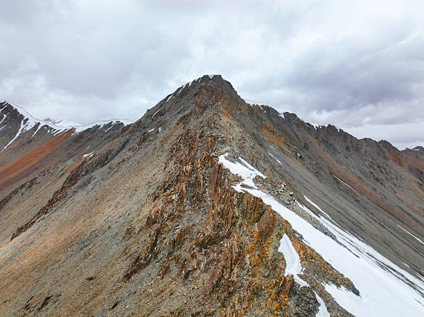 istock Jagged mountain ridge with patches of snow 2239295548