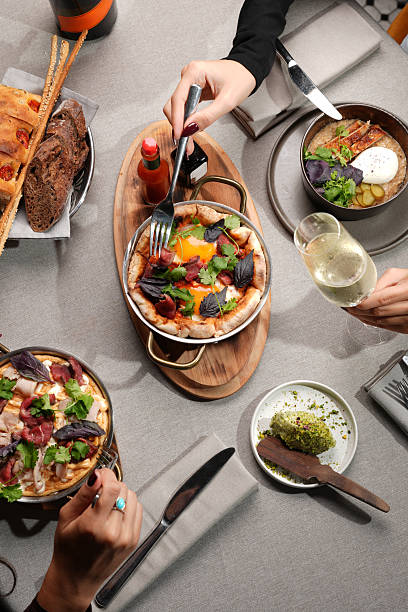 istock riends Toasting with Wine Over Gourmet Brunch 2239297497