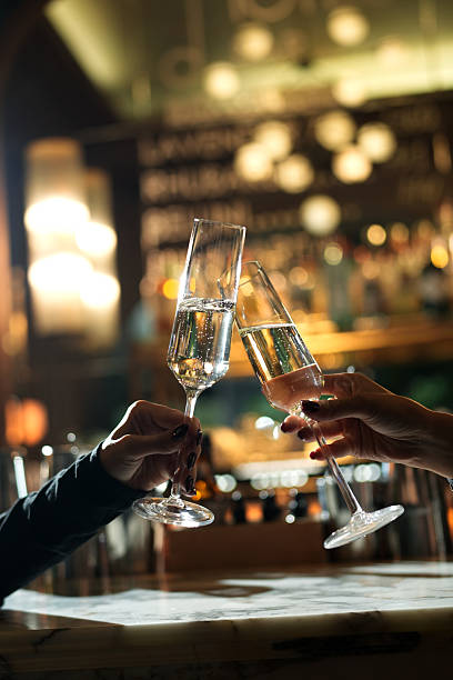 istock Close-up of Two Hands Toasting with Champagne 2239297580