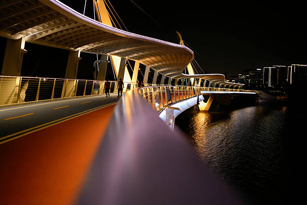 There are still people walking on the bridge at night