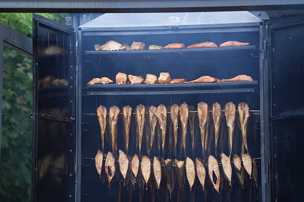 The process of smokehouse is shown, both suspended (whole fish) and on grates (in pieces)