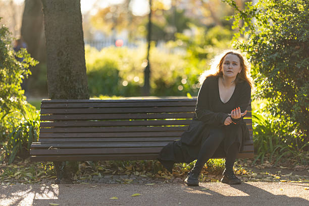 istock Woman experiencing contemplation while sitting on park bench 2239304955