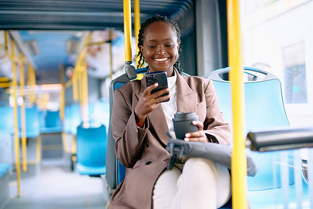 istock Young woman commuting on bus checking phone and drinking coffee 2239307565