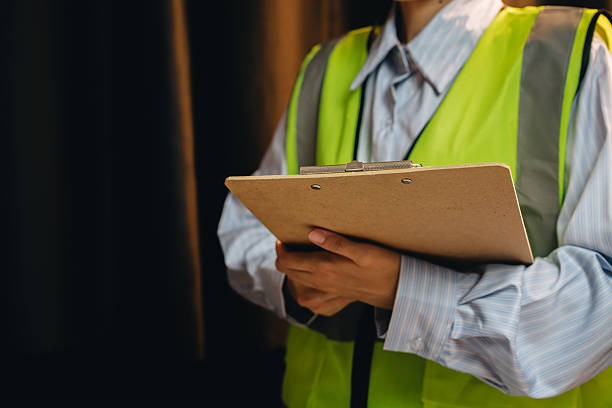 istock Professional construction worker in safety vest holds clipboard while monitoring project on site with focus on safety and accuracy 2239307741